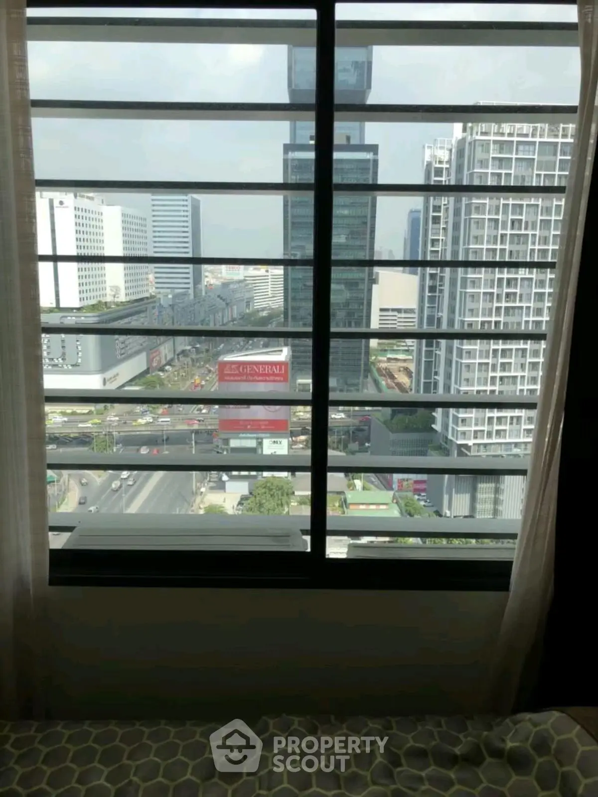 Stunning cityscape view from high-rise apartment window, showcasing modern urban living.