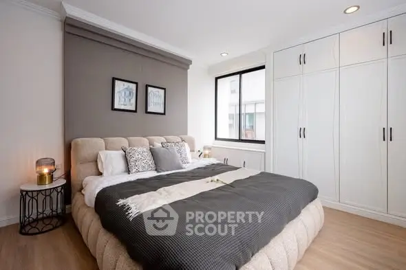 Modern bedroom with stylish decor and ample natural light