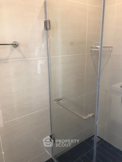 Modern bathroom with glass shower enclosure and sleek tile design