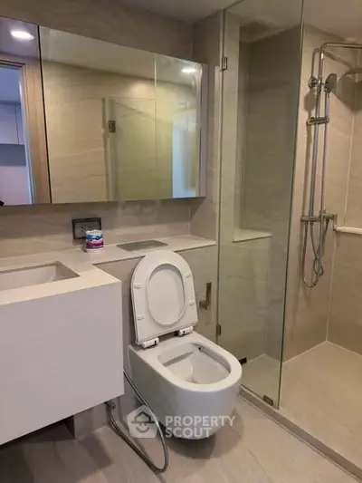 Modern bathroom with sleek fixtures and glass shower enclosure