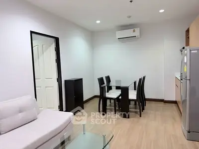 Modern living room with dining area and air conditioning in a stylish apartment.