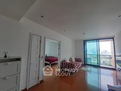 Spacious living room with city view and balcony access in modern apartment.