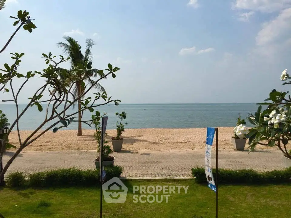 Stunning beachfront view with lush greenery and clear skies, perfect for a serene getaway.