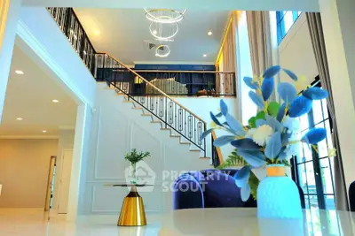 Luxurious modern living room with elegant staircase and stylish decor