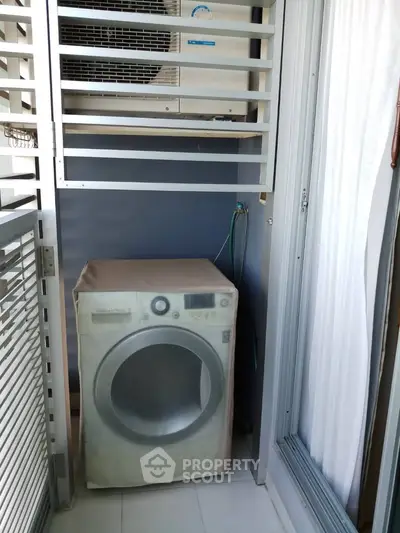 Compact laundry area with washing machine in modern apartment balcony