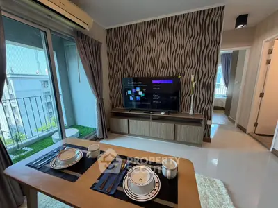 Modern living room with stylish decor and balcony view in a contemporary apartment.