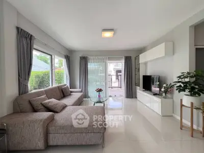 Spacious modern living room with large windows and stylish decor