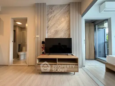 Modern living room with TV stand and open view to bedroom and bathroom