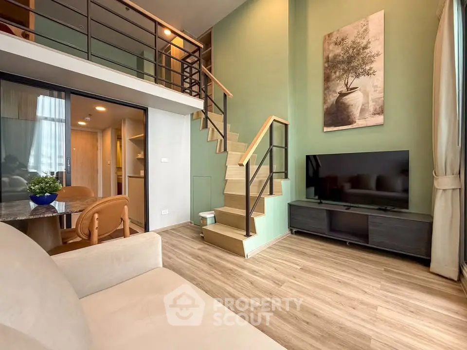 Modern duplex living room with stylish decor and open staircase