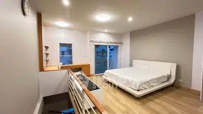 Spacious modern bedroom with balcony and stylish decor