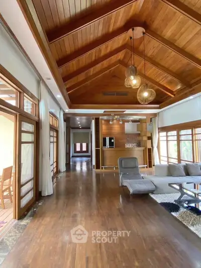 Luxurious living room with vaulted wooden ceiling and modern decor
