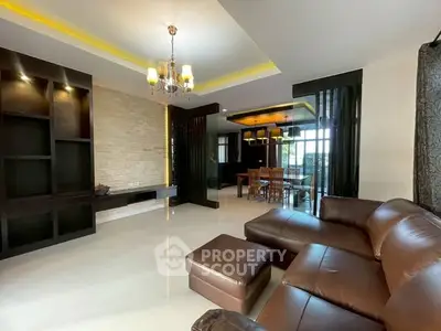 Spacious modern living room with elegant lighting and leather sofa