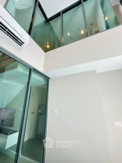 Modern duplex apartment with high ceilings and large windows