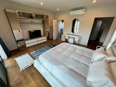 Spacious modern bedroom with elegant decor and wooden flooring