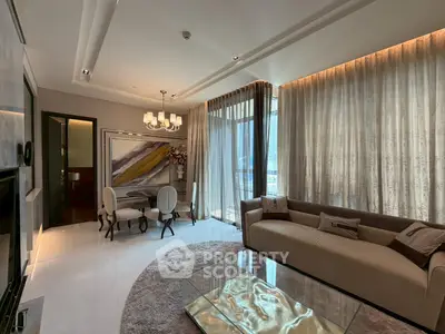 Luxurious living room with elegant decor and floor-to-ceiling windows offering stunning views.