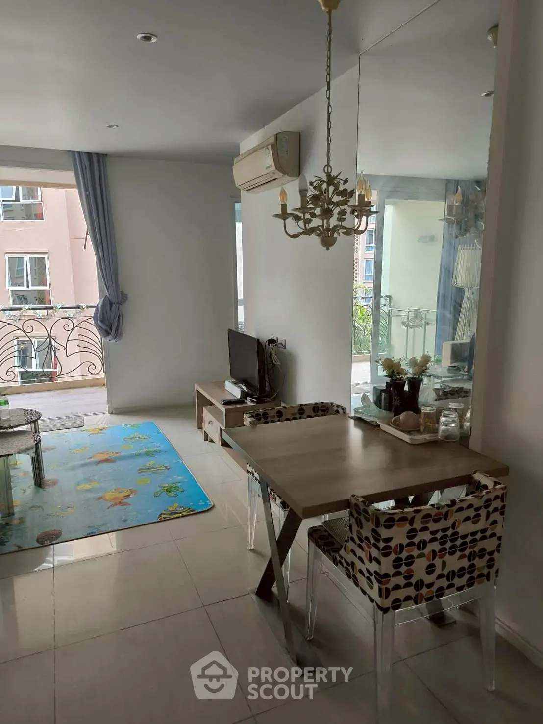 Charming living room with modern decor and balcony view, perfect for cozy urban living.