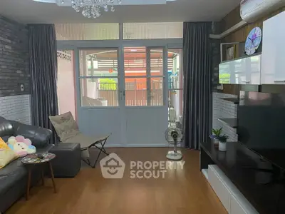 Spacious living room with modern decor and large windows for natural light.