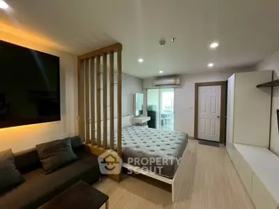 Modern studio apartment with cozy living area and stylish partition