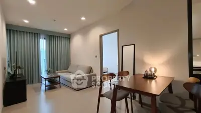 Modern living room with dining area and stylish furniture in a cozy apartment.
