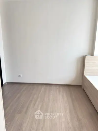 Minimalist bedroom with wooden flooring and modern bed frame