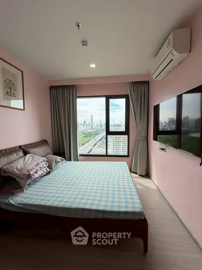 Cozy bedroom with city view, featuring a comfortable bed and modern decor, perfect for urban living.