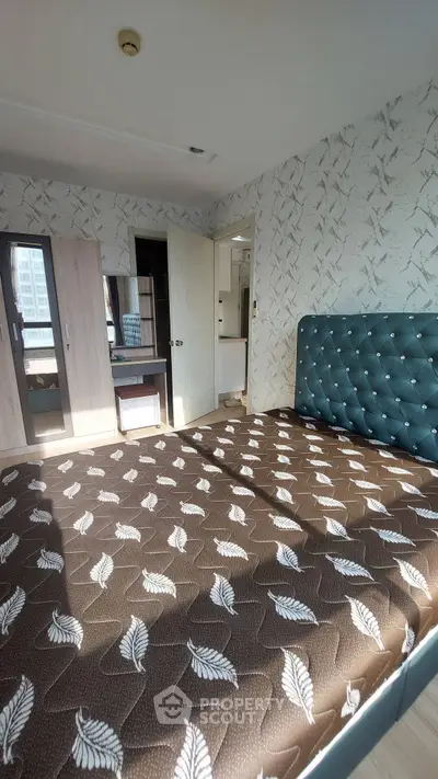 Spacious bedroom with stylish decor and ample natural light