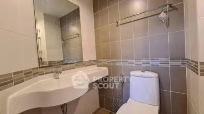 Modern bathroom with sleek fixtures and neutral tile design, perfect for a contemporary home.