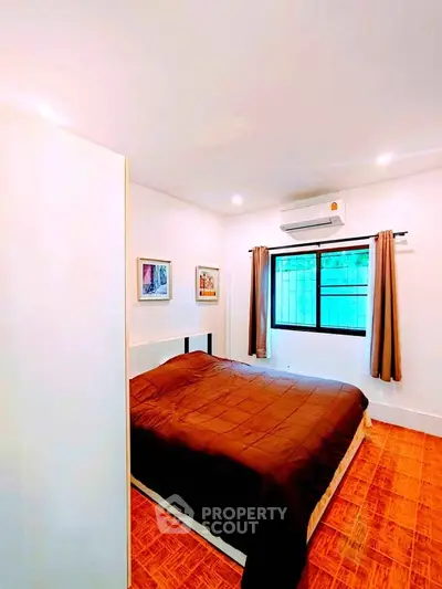 Cozy bedroom with modern decor and air conditioning, perfect for restful nights.