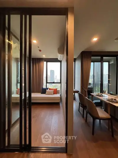 Modern apartment with city view, featuring a cozy living area and dining space.