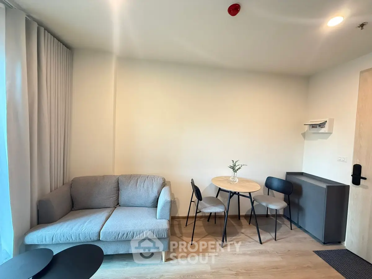 Modern living room with cozy sofa and dining area in a stylish apartment.