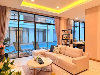 Luxurious living room with pool view and elegant decor