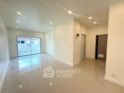 Spacious modern living room with glossy tile flooring and recessed lighting