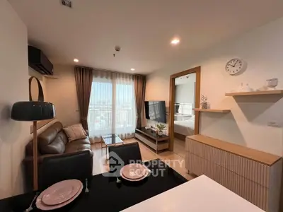 Modern living room with open layout, stylish furniture, and large windows offering a stunning city view.