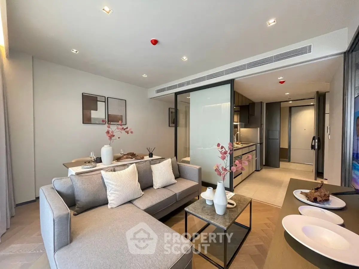 Modern open-plan living room with stylish decor and sleek kitchen