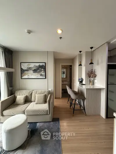 Modern living room with stylish decor and open kitchen layout in a cozy apartment.