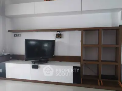 Modern living room with sleek TV unit and minimalist shelving