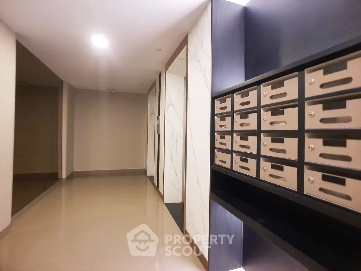 Modern apartment building corridor with mailboxes and polished floors