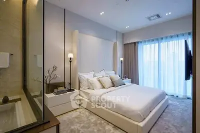 Luxurious modern bedroom with elegant decor and large windows for natural light.