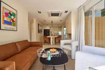 Modern living room with stylish furniture and open kitchen layout