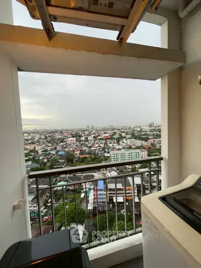 Stunning city view from high-rise balcony with laundry area