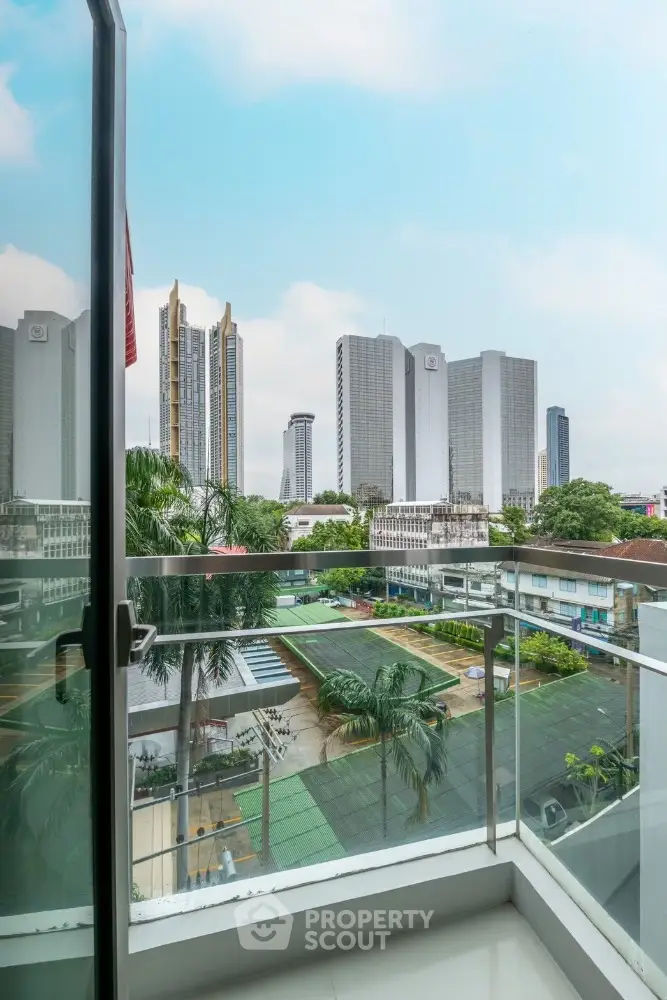 Stunning city view from modern balcony in high-rise apartment