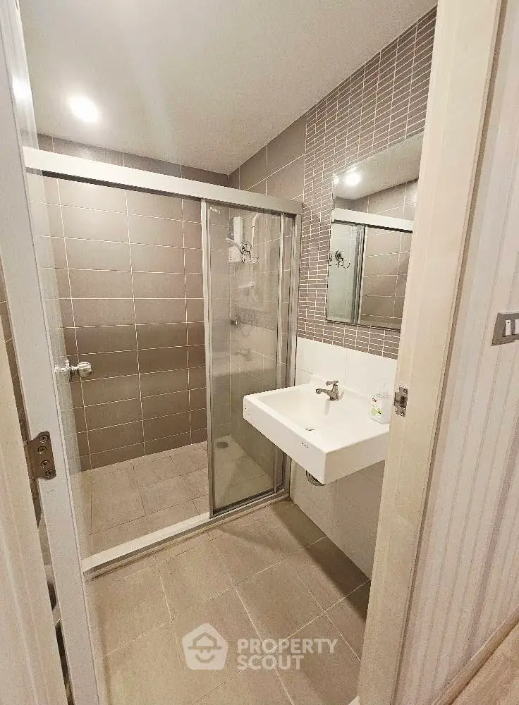 Modern bathroom with glass shower and sleek sink design