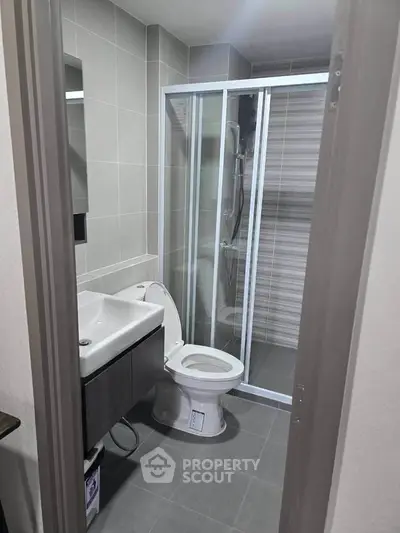 Modern bathroom with sleek design featuring glass shower and contemporary fixtures.