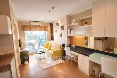 Modern living room with stylish decor and balcony view in a cozy apartment.