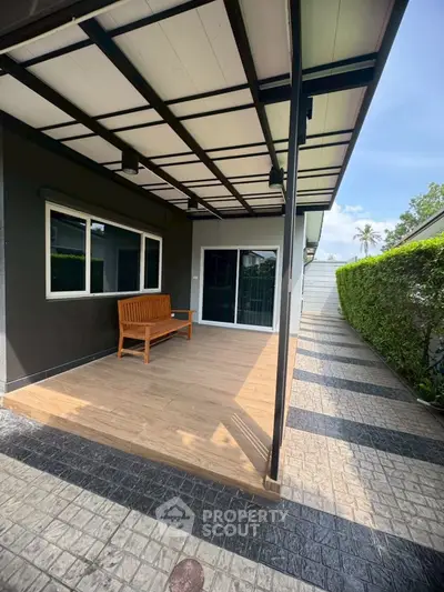 Charming modern patio with wooden bench and sleek design, perfect for outdoor relaxation.