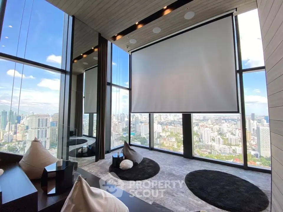 Luxurious high-rise living room with panoramic city views and modern decor.
