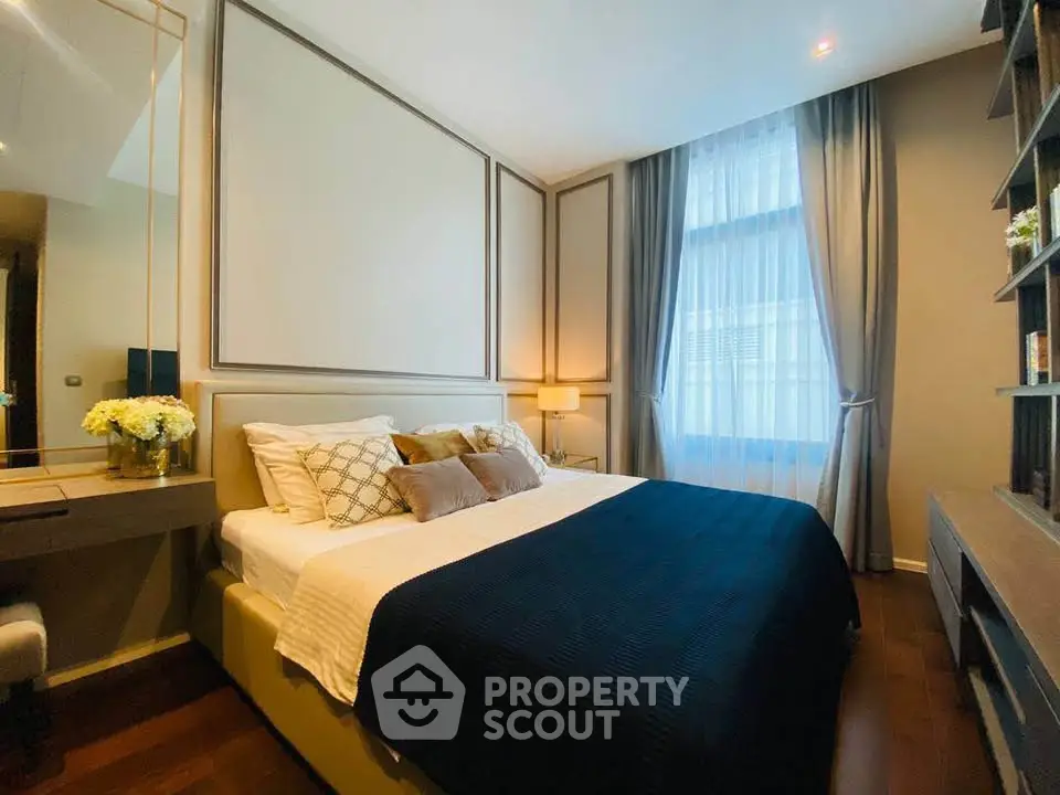 Luxurious bedroom with elegant decor and large window for natural light.