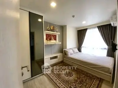 Cozy bedroom with elegant decor and ample natural light, featuring a stylish wardrobe and plush carpet.