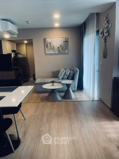 Modern living room with stylish decor and open layout, featuring a cozy sofa and elegant dining area.