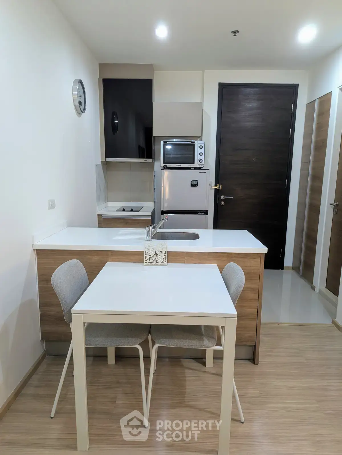 Modern kitchen with sleek appliances and dining area in a stylish apartment.
